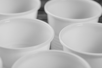 A group of white plastic cups mounted on a black table