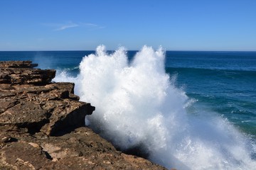 Fototapeta na wymiar Big ocean waves crashing against the rocks at the west coast of the island of Fuerteventura, Spain. Beauty and power of the nature