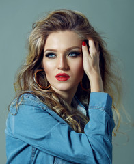 Fototapeta premium Portrait of a beautiful young girl with bright makeup in a fashionable denim shirt.