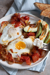 Tasty and Healthy Shakshuka. Eggs Poached in Spicy Tomato Pepper Sauce.