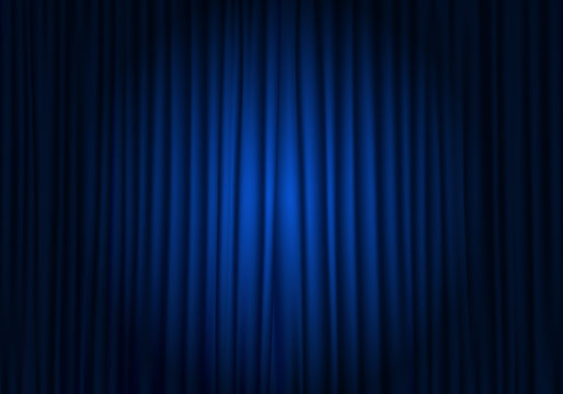 Spotlight on stage curtain. Closed blue curtain background. Theatrical drapes.