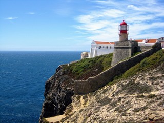 Fototapeta na wymiar Lighthouse at the Cape St. Vincent (Lighthouse of Cabo de São Vicente), located on a high cliff. The most southwestern point of Portugal and of mainland Europe
