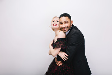Happy lovely moments cute couple in-love hugging on white background. Luxury evening dress, expressing true positive emotions, Valentines day, happiness together, sweathearts
