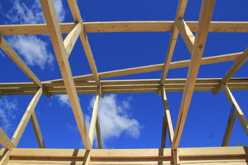 Wood frame residential building under construction under blue sky