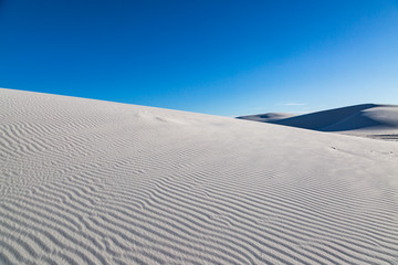 Fototapeta na wymiar Light and shadow on the gypsum sand dunes, at White Sands National Monument, New Mexico