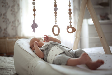 newborn baby sleeps in special mattress device