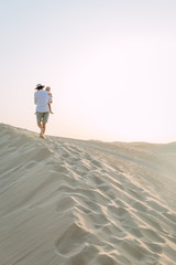 Father holding his little daughter in the desert in Dubai