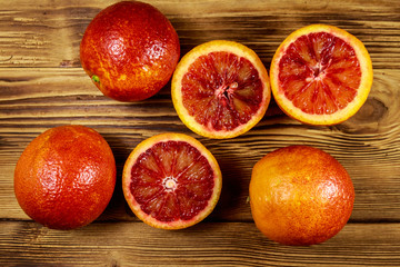 Red blood oranges on wooden table. Top view
