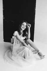 Obraz premium attractive fashionable woman posing in pink dress on a white background in the studio