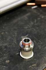 Part of a metal air filter laid on the table.