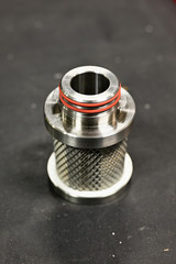 Part of a metal air filter laid on the table.