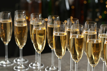 Many glasses of champagne on blurred background, closeup