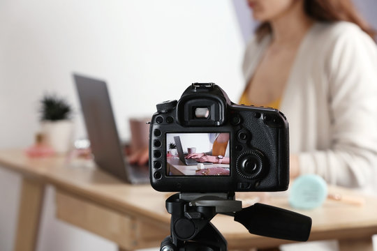 Photo of blogger at workplace on camera screen, closeup with space for text
