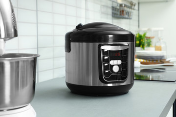 Modern multi cooker on table in kitchen