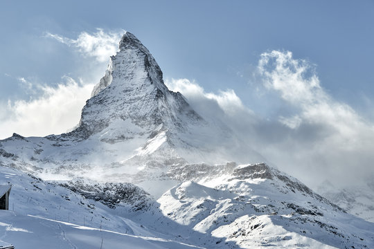 Outstanding  view of Matterhorn covered by clouds with strong wind