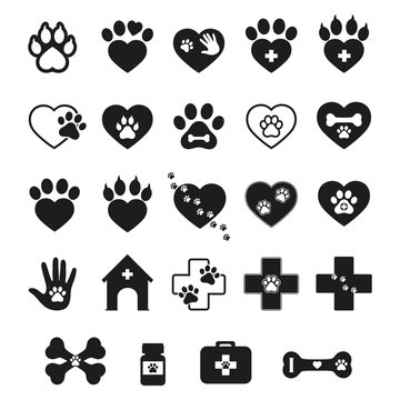 set of veterinary emblems with the image of dog and cat tracks in the heart and medical cross on a white background