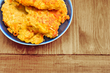 Diet vegetable cutlet from carrot, zucchini, potato on wood table. Healthy food