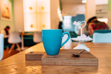 Fototapeta na wymiar Hot cappuccino coffee in coffee shop on wooden table