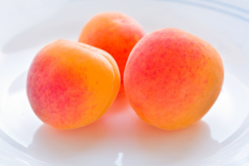 Organic dried fresh apricots on white in vintage style