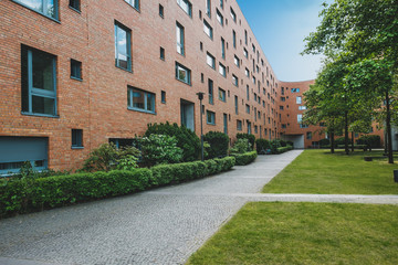  residential building exterior with park and meadow - apartment house