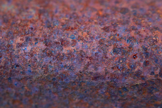 Curved rusty metal surface, macro, narrow depth of field