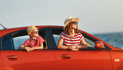 happy family mother and child girl goes to summer travel trip in car