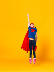 concept of child superhero costume on yellow background