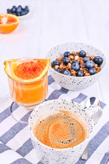 Traditional european breakfast on white wooden background. Muesli with berries and orange juice.