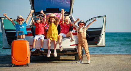 group happy children girls and boys friends   on   car ride to summer trip.