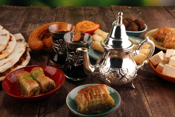 Middle eastern or arabic dishes and assorted meze, concrete rustic background. Turkish Bread or Turkish pizza. Dessert Baklava with pistachio. falafel with hommos.  Halal food. Lebanese cuisine
