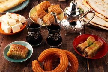 Middle eastern or arabic dishes and assorted meze, concrete rustic background. Turkish Bread or Turkish pizza. Dessert Baklava with pistachio. falafel with hommos.  Halal food. Lebanese cuisine