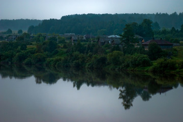 Fototapeta na wymiar Silence early in the morning in the village on the river