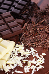 chocolate in diffrent color. milk, dark and white chocolate bars on table
