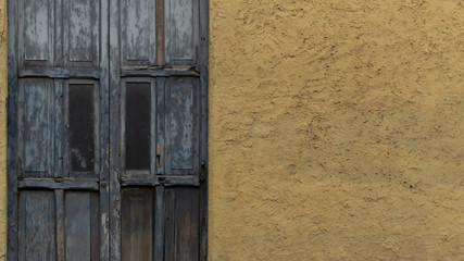 old wooden door in yellow wall
