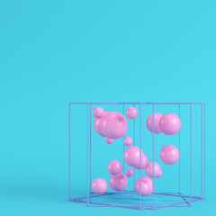 Abstract spheres in wire box on bright blue background in pastel colors. Minimalism concept