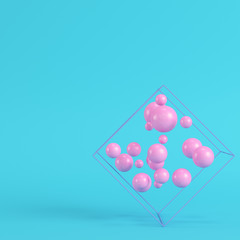 Abstract spheres in wire box on bright blue background in pastel colors. Minimalism concept