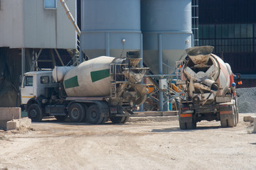 Two large cement truck trucks brought cement to the industrial area of the plant in special...