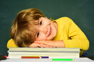 Great study achievement. Funny little boy pointing up on blackboard. Happy school kids. School kids. Kids gets ready for school.