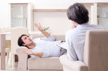 Young male patient discussing with psychologist personal problem