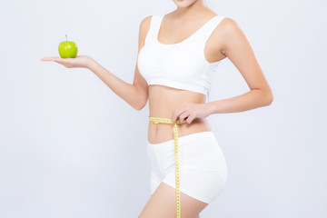 Beautiful asian woman diet and slim with measuring waist for weight and holding green apple fruit...