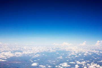 Blue sky background and white clouds soft focus, top view take a picture on airplane.