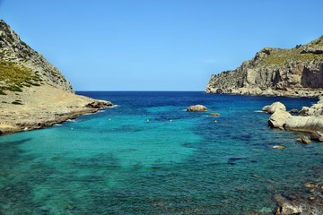 Fototapeta premium Sea bay with turquoise water, beach and mountains, Cala Figuera on Cap Formentor