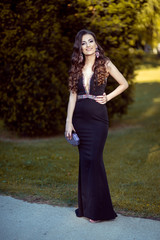Beautiful young lady in luxury black dress is ready for her prom night © Kostadin