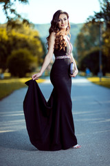 Beautiful young lady in luxury black dress is ready for her prom night © Kostadin