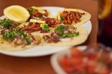 Mexican Tacos "Pastor" and "Carnitas" with pork and beef in yellow tortilla