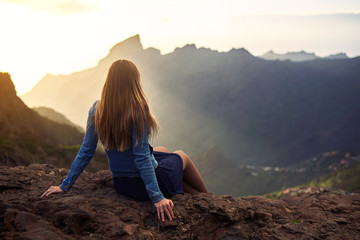 Young woman contemplating the road to Masca in Tenerife, Canary Islands, Spain