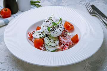 Vegetable salad with poached egg and sour cream