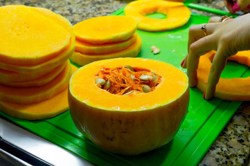  Removing the seeds from the squash to prepare slices in the oven.