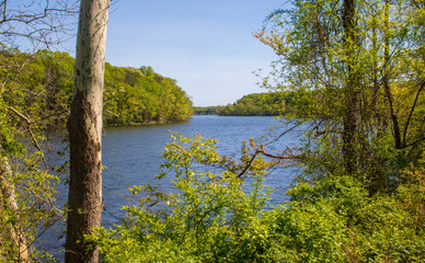 Connecticut River in spring with a railroad bridge in the distance
