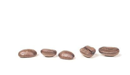 Five coffee beans dark roasted isolated on white background